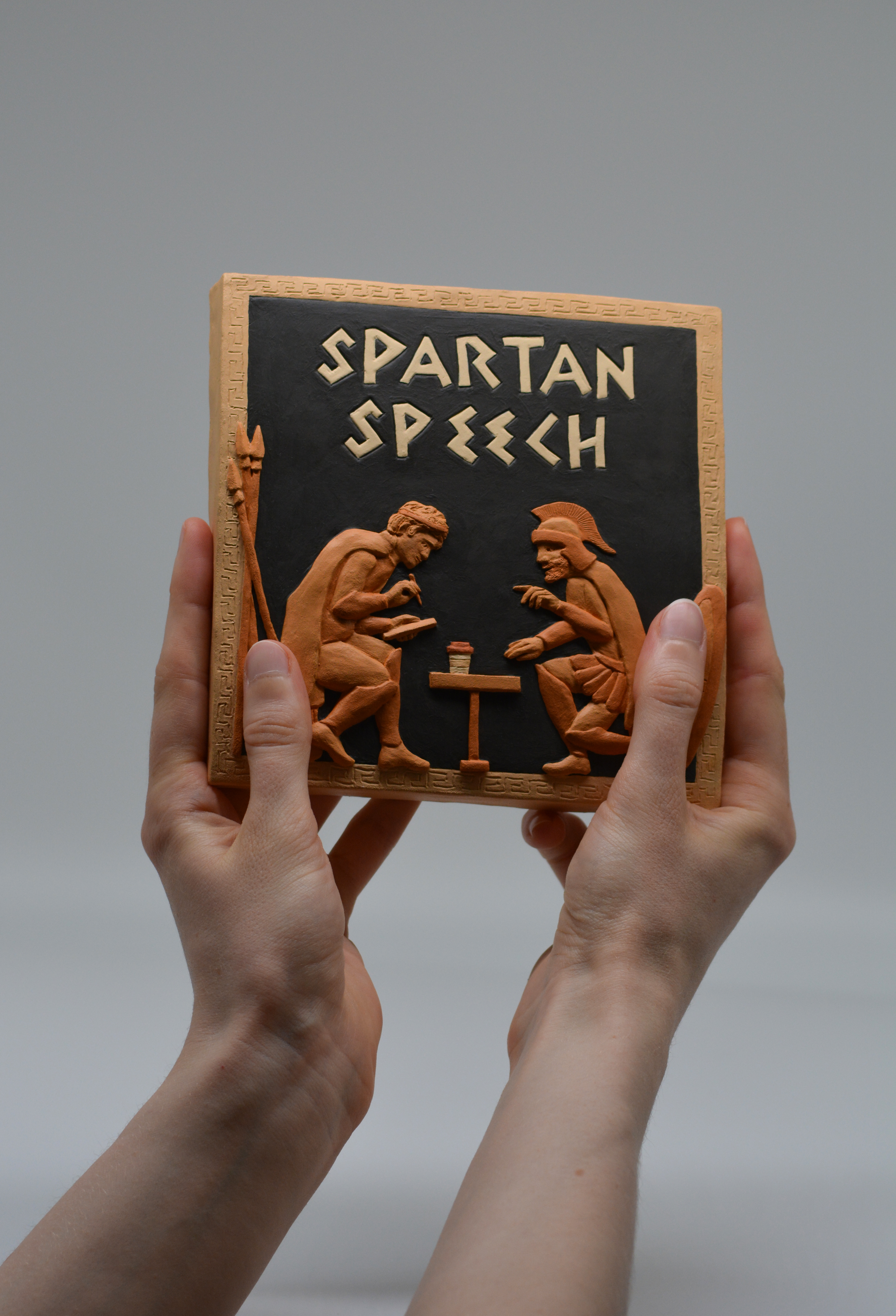 Spartan Speech ceramic cover art held by artist